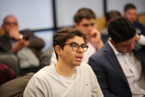 Man asks questions from audience.