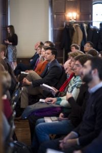 Audience listens to speakers.