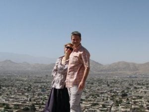 Man and woman pose for photo on a sunny day.