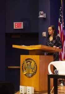 Woman speaks at a podium.