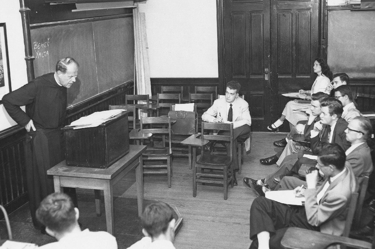 Lone female sitting in class with Father Frank Fadner