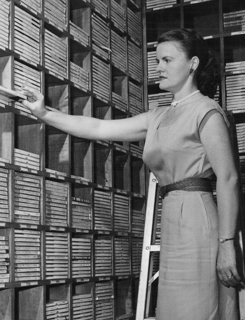 Female student arranges audio tapes