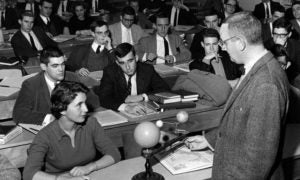 A woman student sits in the front of a class circa 1960.