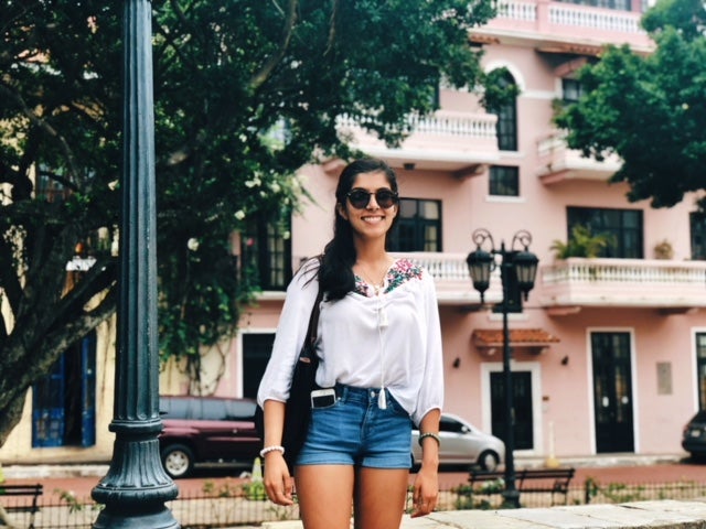 Woman poses for photo outside.