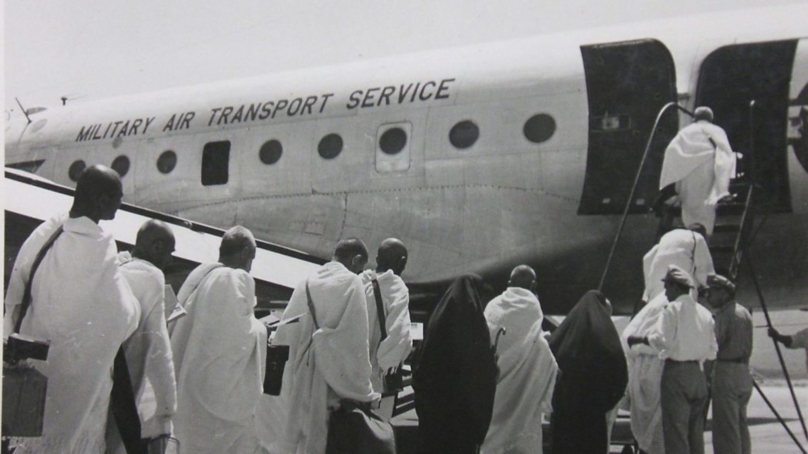 Men boarding military air transport plane