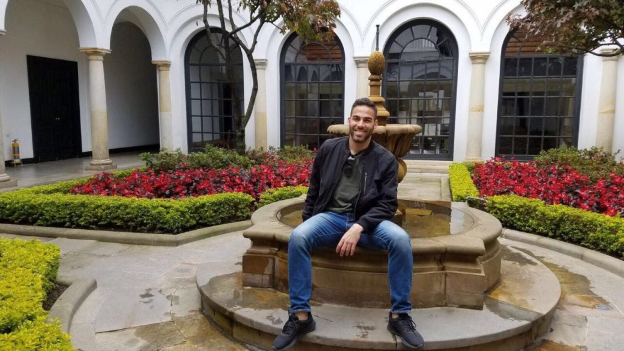 Alexander Causwell posing in front of water fountain