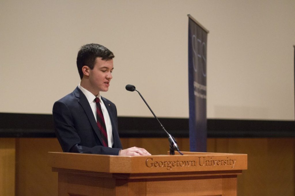 Man speaks from podium.