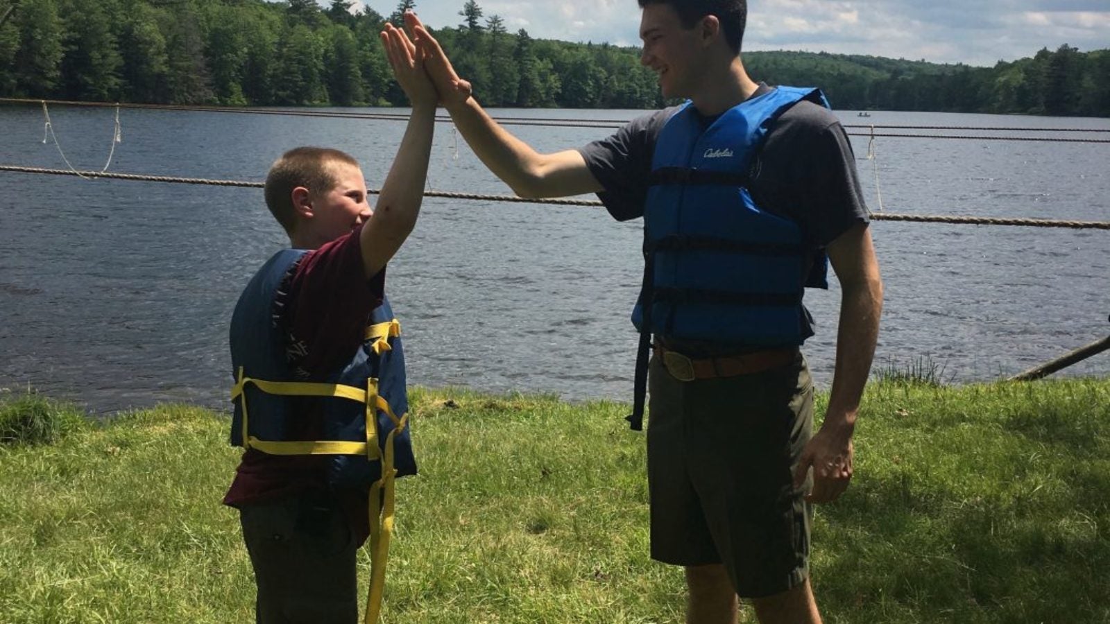 Gertin Header high fiving younger boy