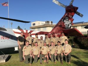 Scouts in front of navy helicopter