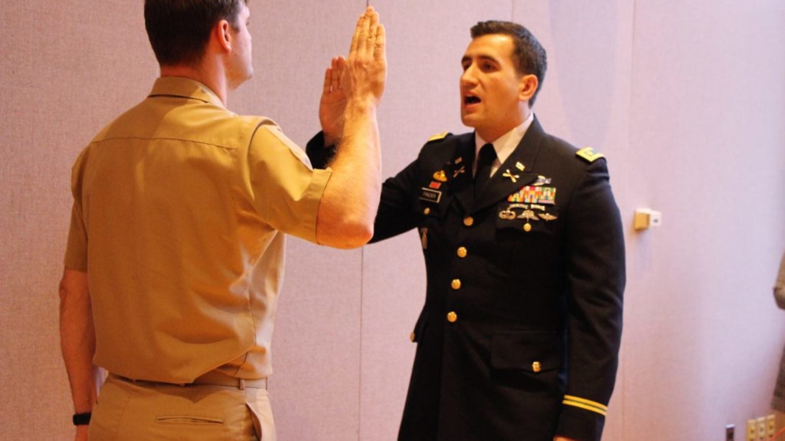 Lieutenant Commander Josh Parsons with right hand raised