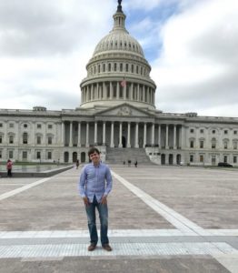 Man poses in front of U.S. Capitol.