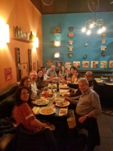 Group of people at restaurant pose for photo.