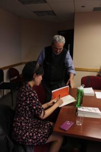 Kuang signing books for audience members 