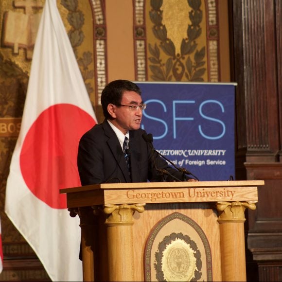 Foreign Minister of Japan speaking at podium of Gatson Hall