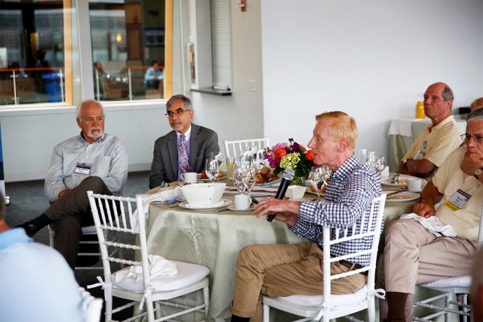 alumni around table for reunion weeken