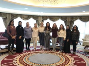 Group poses for photo in elegant room.
