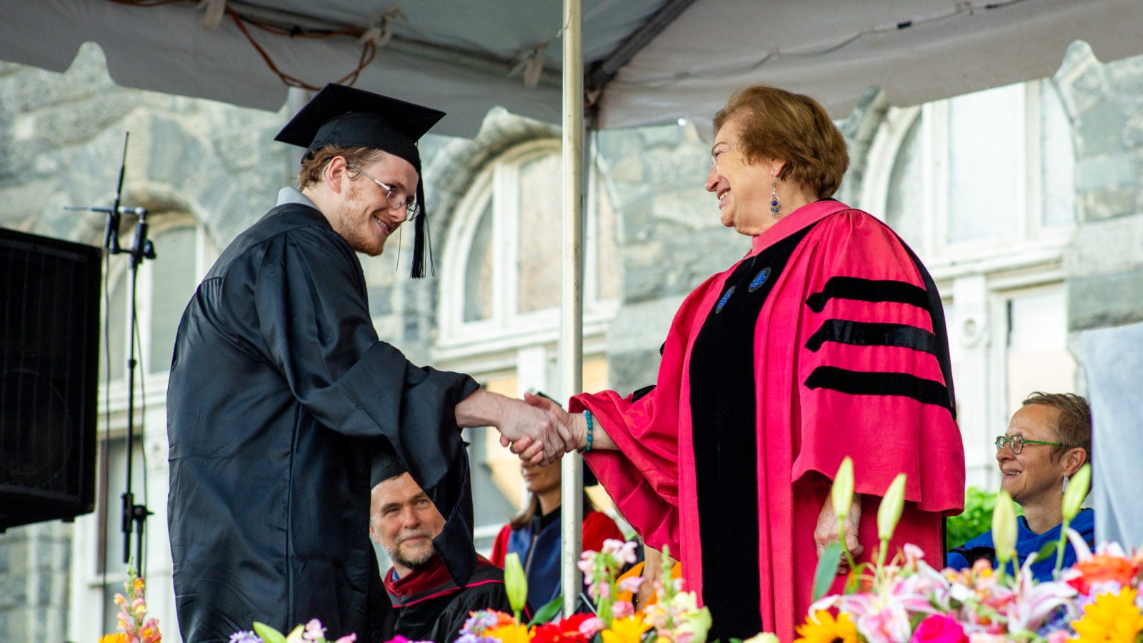 Graduate shaking hands with staff