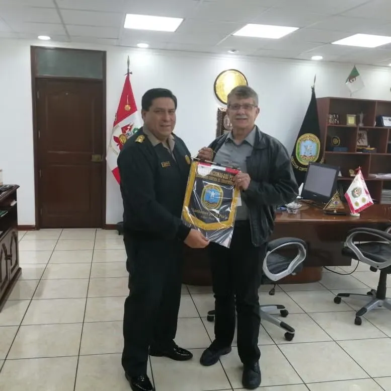 Steve McFarland in Peru standing with Peruvian officer.