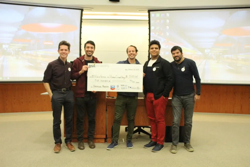 A team of five men who won honorable mention in the Social Innovation Lab competition, holding $500.00 check.