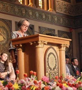 Lahra Smith at the podium in Georgetown's Gaston Hall. 