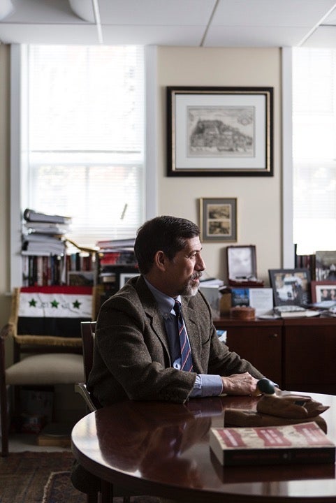 Professor Hoffman sits at a round table in his campus office.