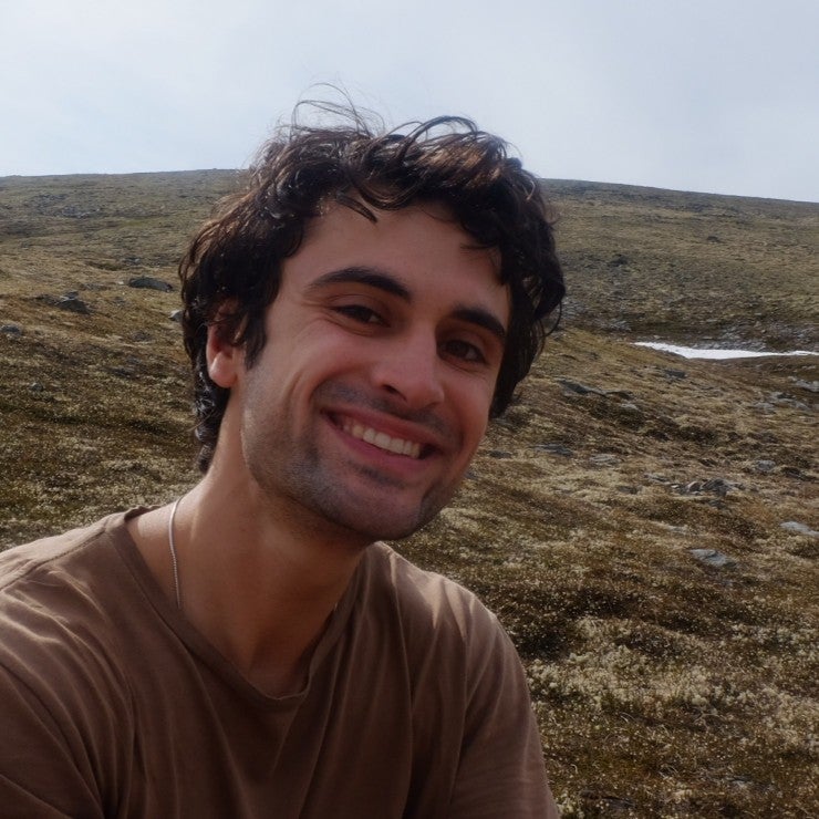 Brian Britt in front of a rocky, mountainous landscape.