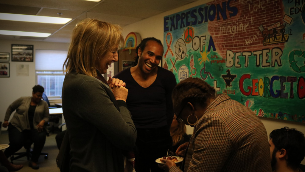 Teak Hodge (SFS'21) laughs with visitors to Georgetown's LGBTQ Resource Center