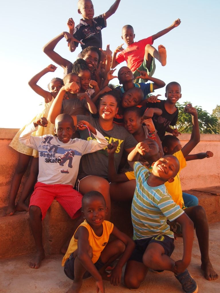 A photo of Nicole surrounded by students in her after-school exercise class.