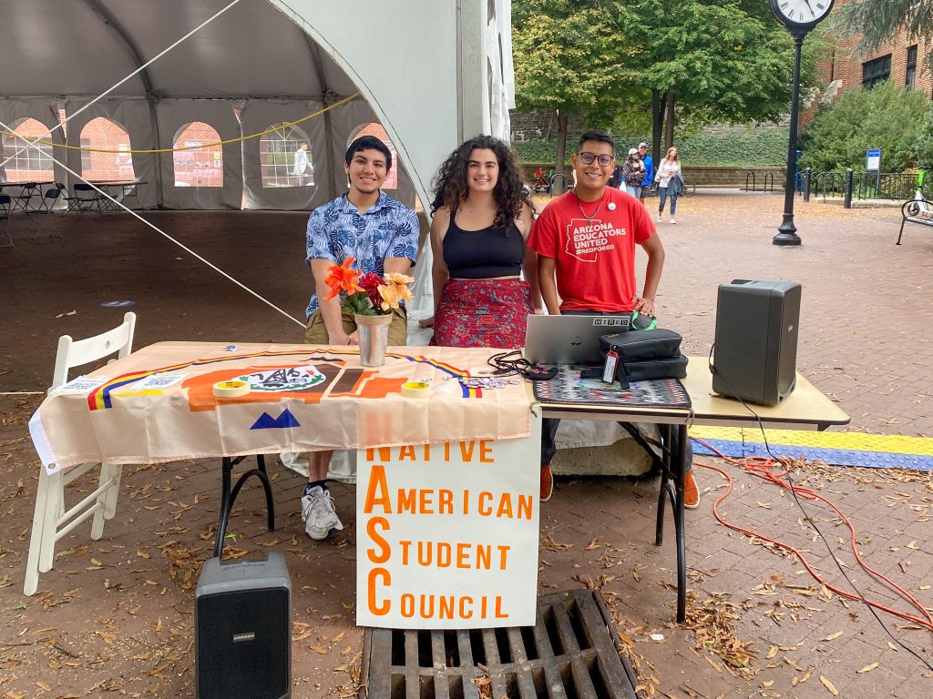 A photo of Sam and two other students tabling for the Native American Student Council in Georgetown's Red Square.