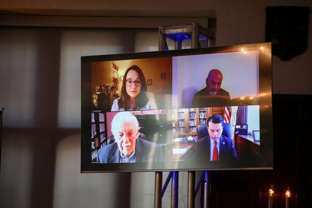 Screen in Copley Hall shows participants in last panel of the day