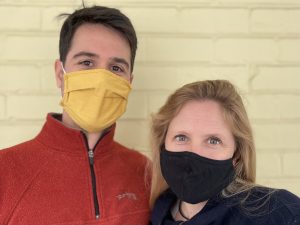 Photo of Dr. Emily Mendenhall and her husband both wearing masks.