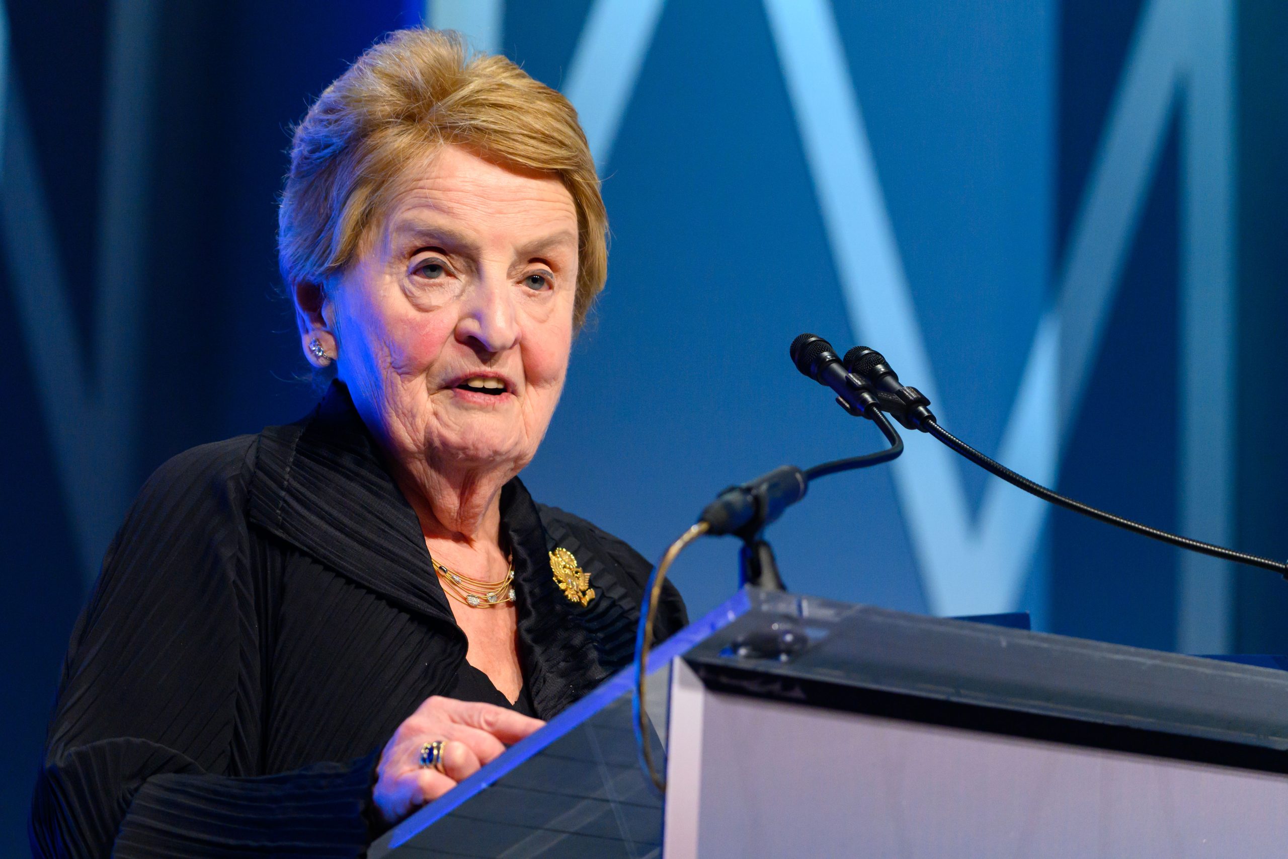 Madeleine Albright speaks from a podium at the SFS Centennial Gala dinner