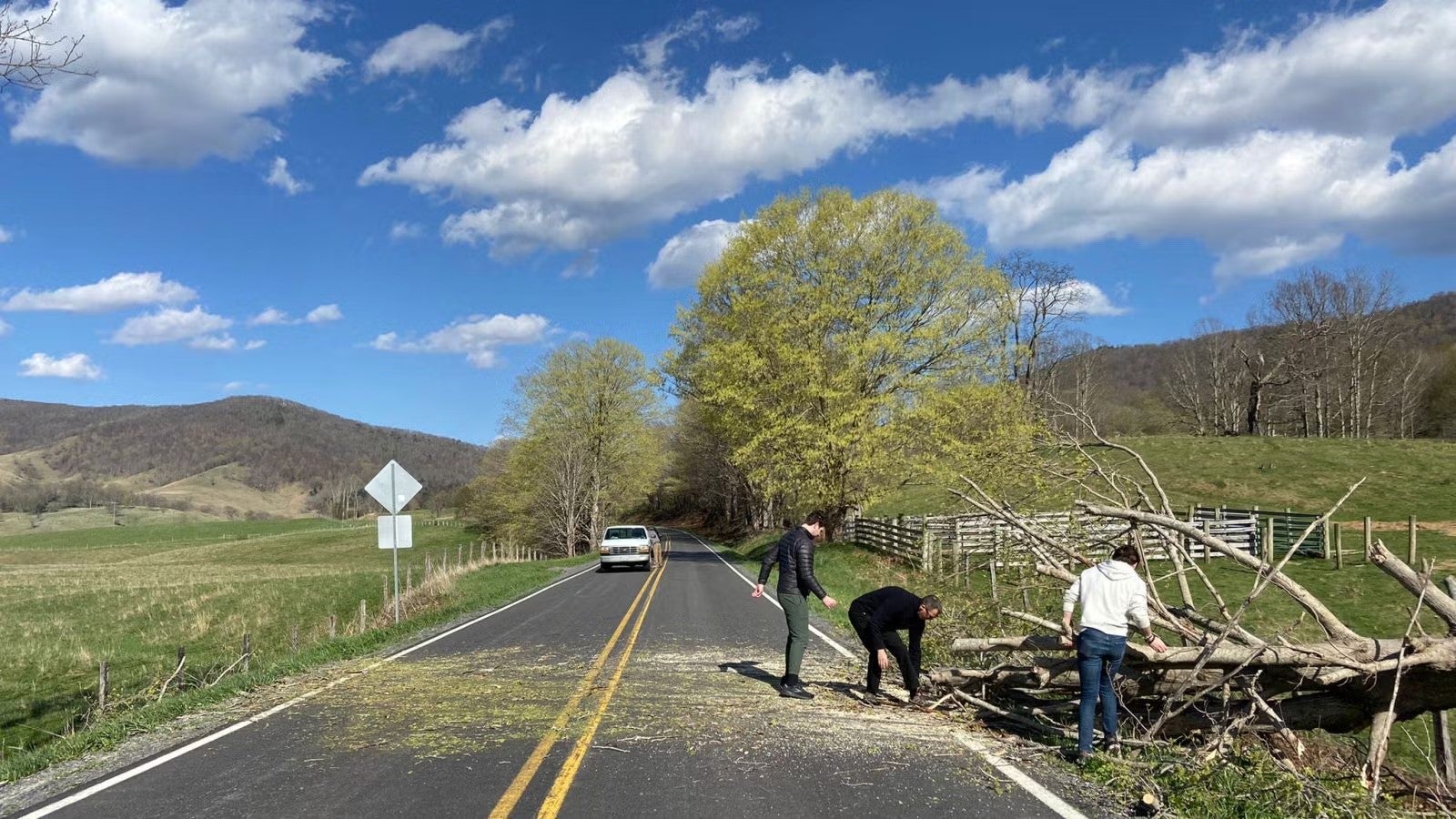 Students helping to remove downed tree blocking roadway. Road is now nearly cleared of debris.