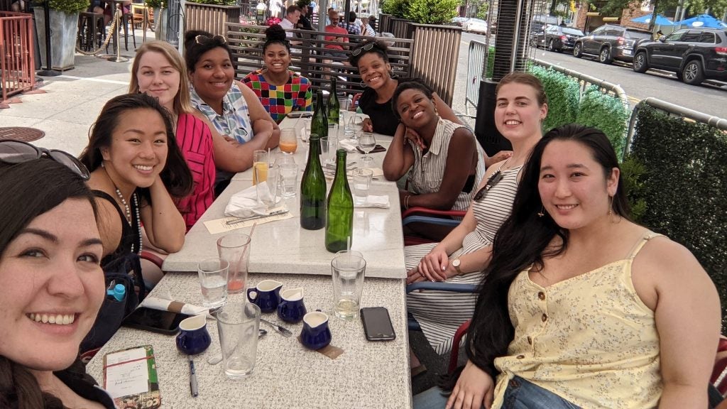 GWIA members pose for a selfie around a table.