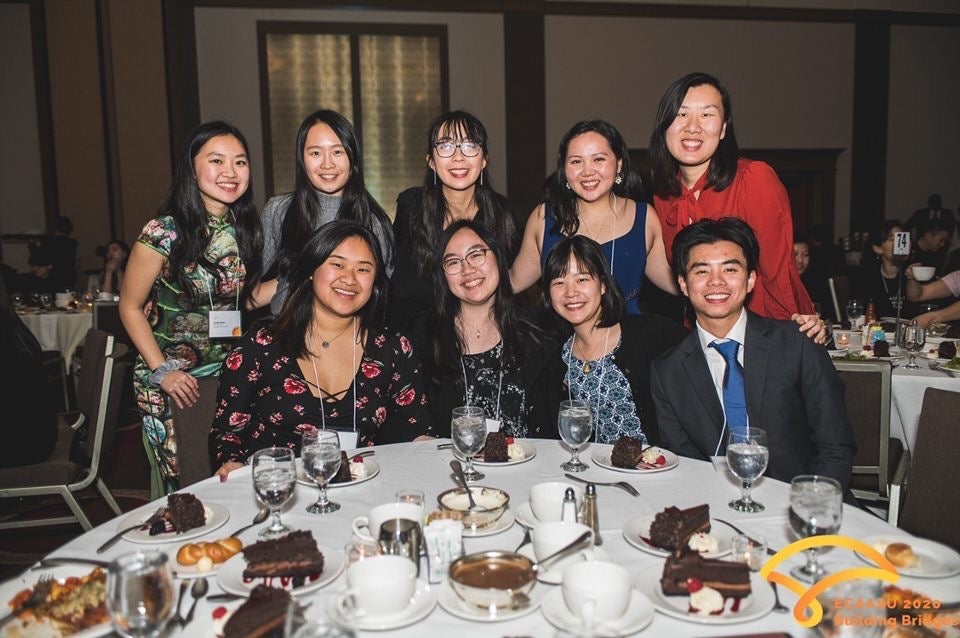 Students pose at dinner table