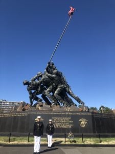 A photo of Chelius and a fellow Marine standing in front of Iwo Jima.