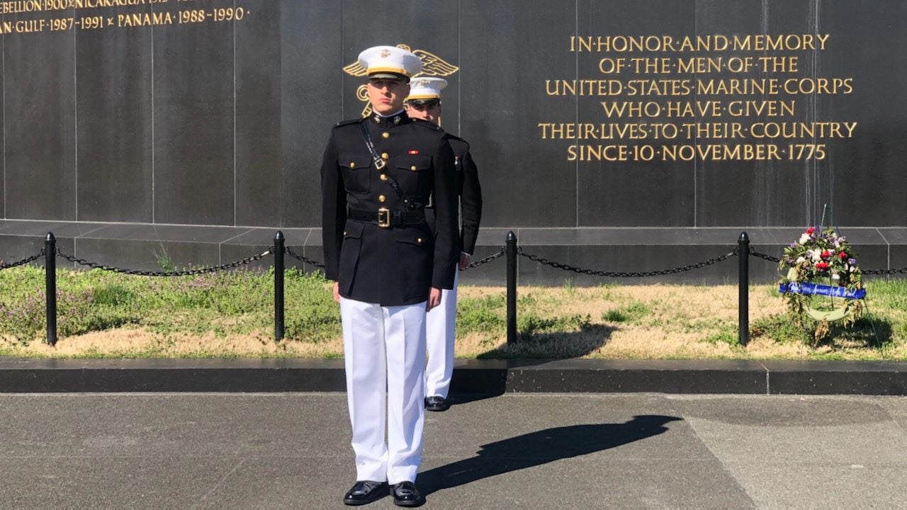 A photo of Chelius and a fellow Marine standing at the base of Iwo Jima.