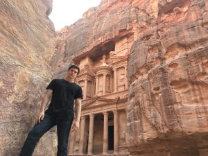 A photo of Eosin Chelius (SFS'22) standing in front of the city of Petra.