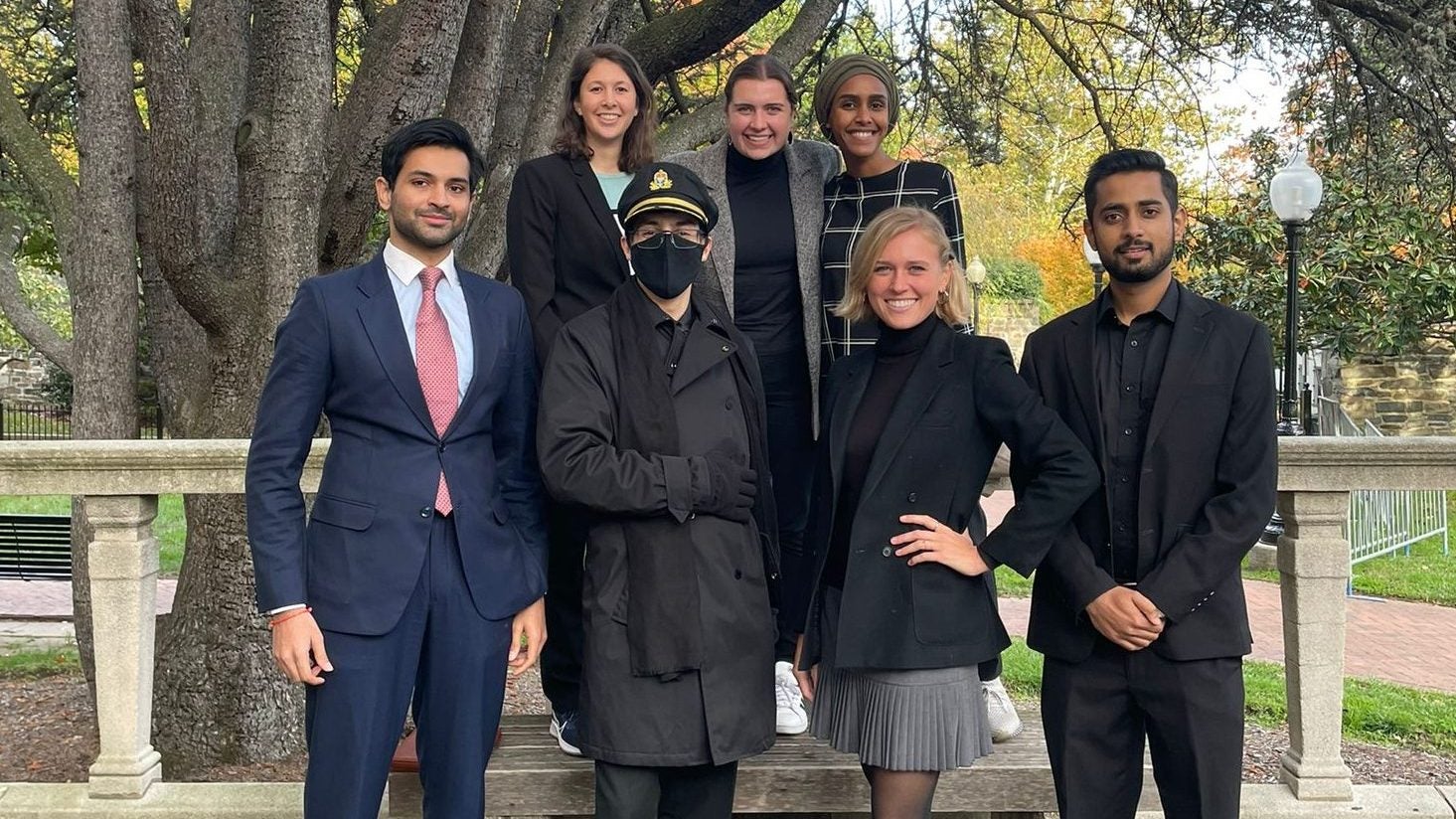 Group of students pose standing in formal wear.