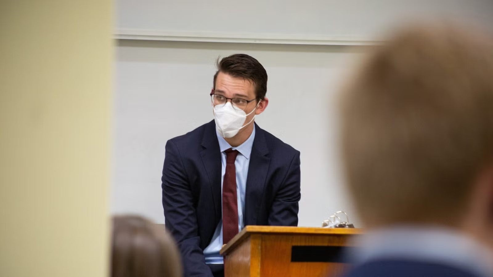 Chris standing at podium in front of classroom during foreign policy crisis simulation.