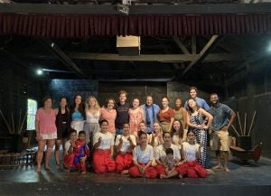 Georgetown Students smile with an all-female drum troupe following an interactive traditional drumming performance and workshop.