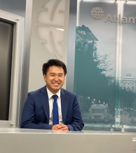 Brian Zhu sits at a desk in an Atlantic Council room