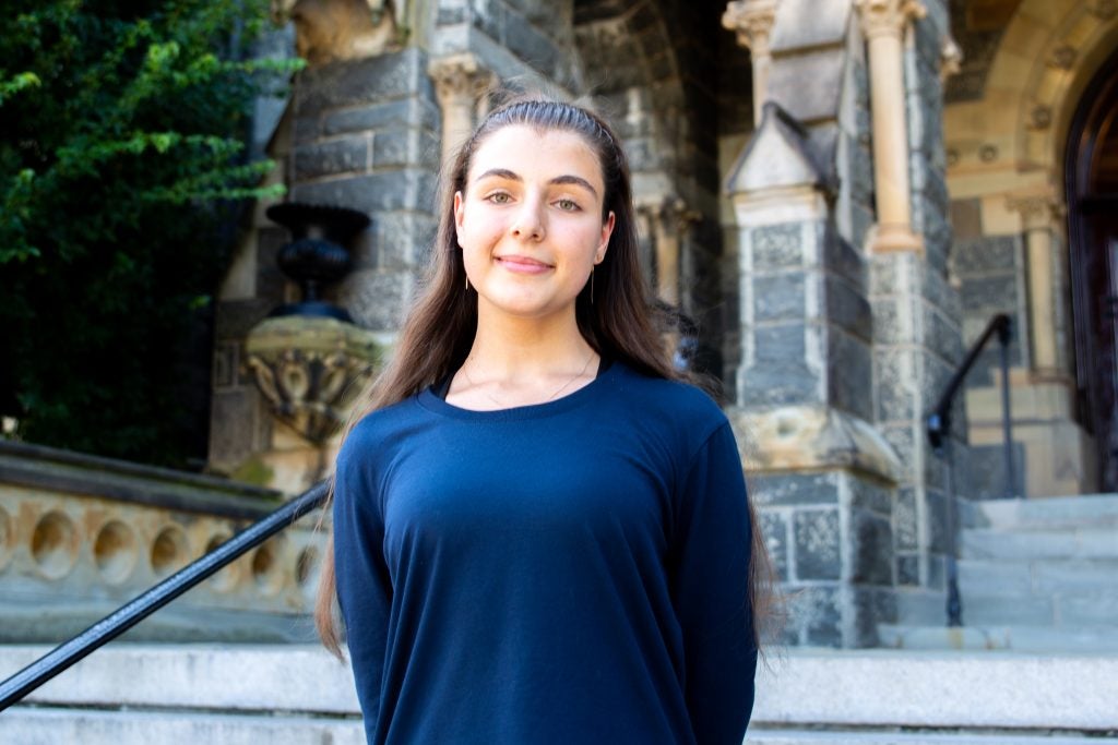 Headshot of Tetiana Tkachenko smiling in front of Healy Hall