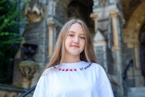 Headshot of Tetiana Tkachenko smiling in front of Healy Hall