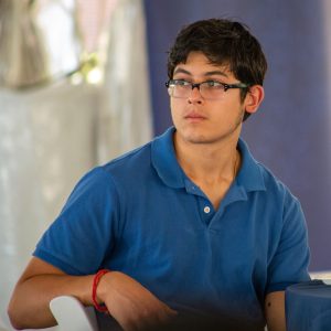 A fellow sits at a table looking to the left