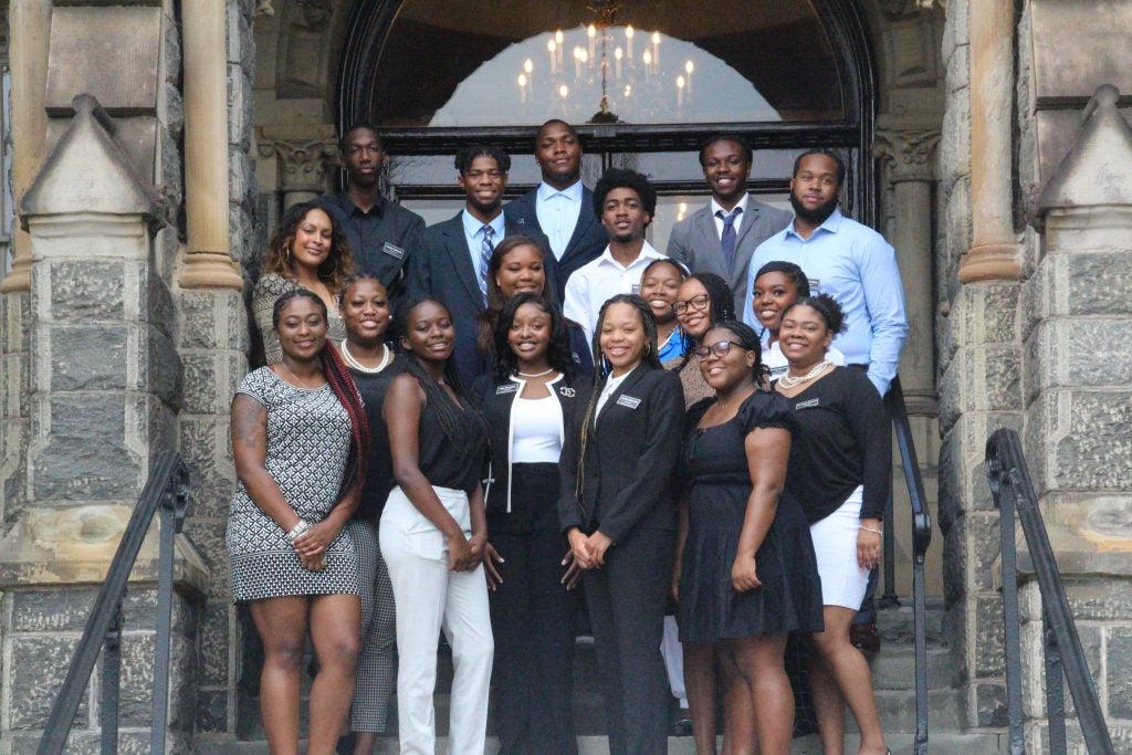 Program participants stand on Healy steps for a group photo