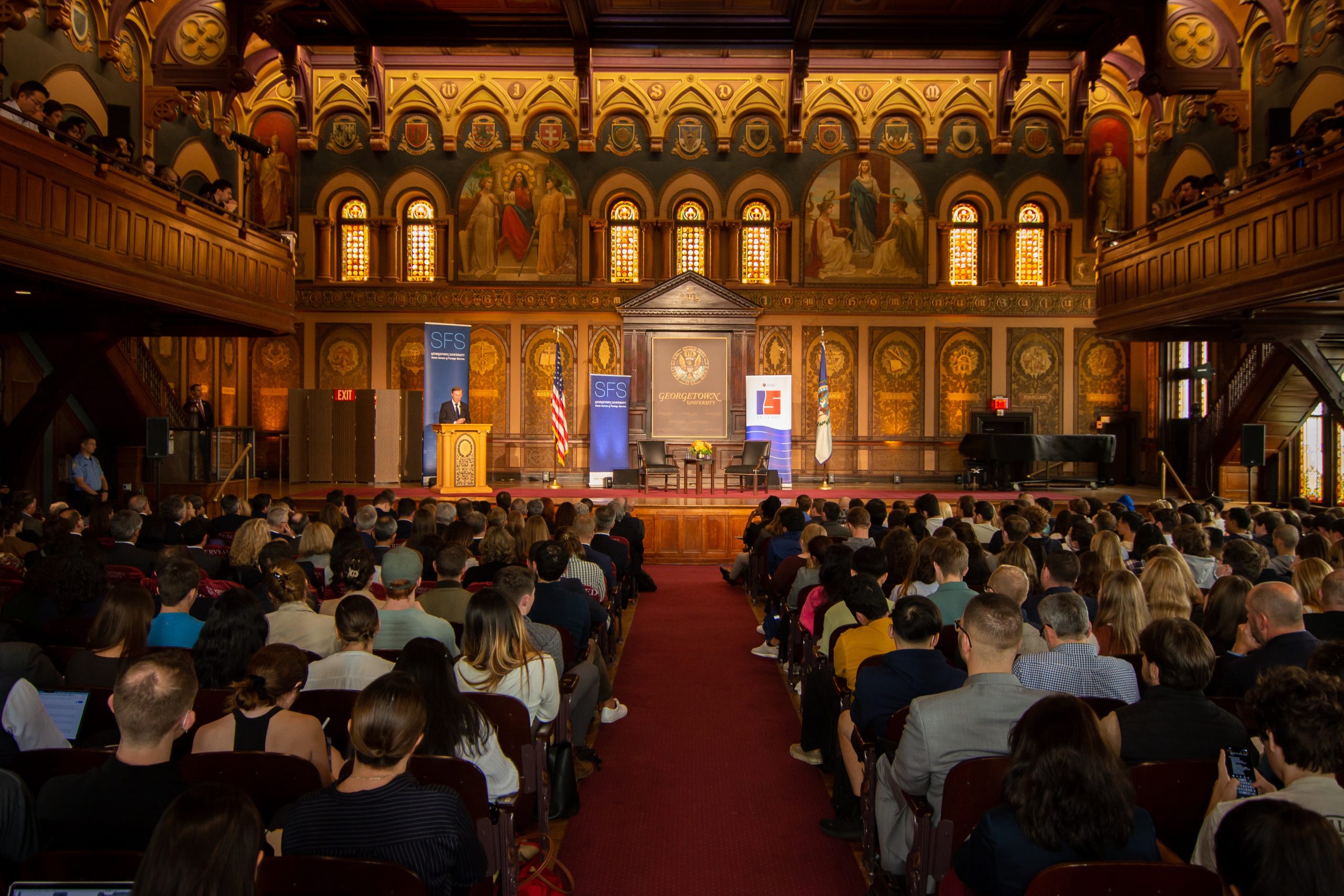 Wide shot of Gaston Hall, with Sullivan on-stage during his solo remarks.