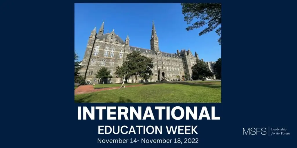 Healy Hall from the lawn on a sunny, cloudless day. Text superimposed on image states "International Education Week" in white sans serif font on a navy background.