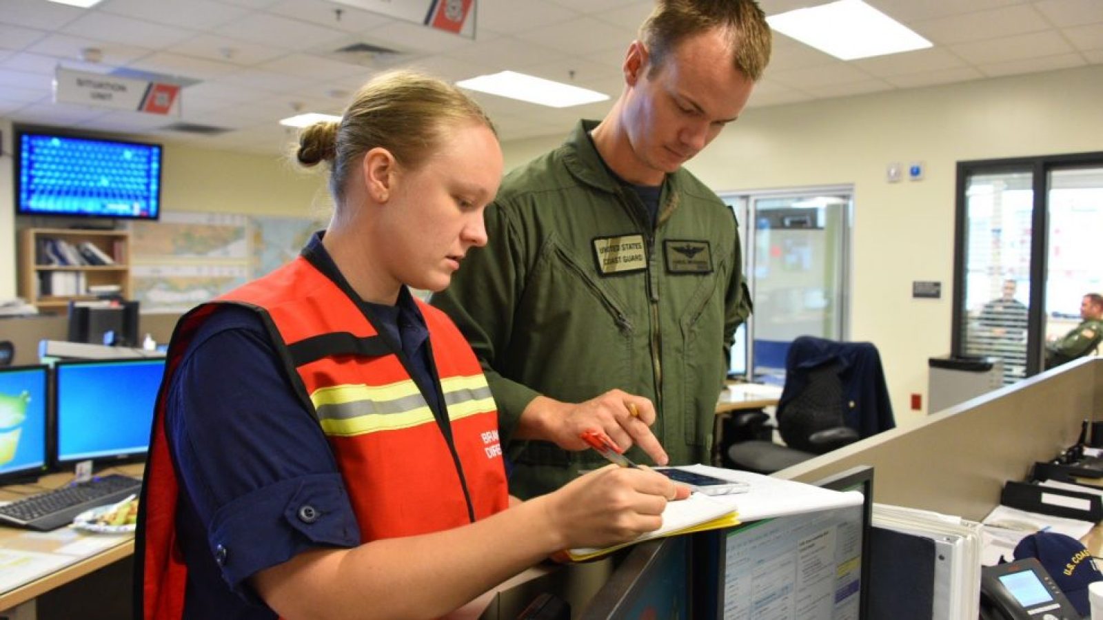 McCafferty (left) works on an assignment during her service with the Coast Guard.
