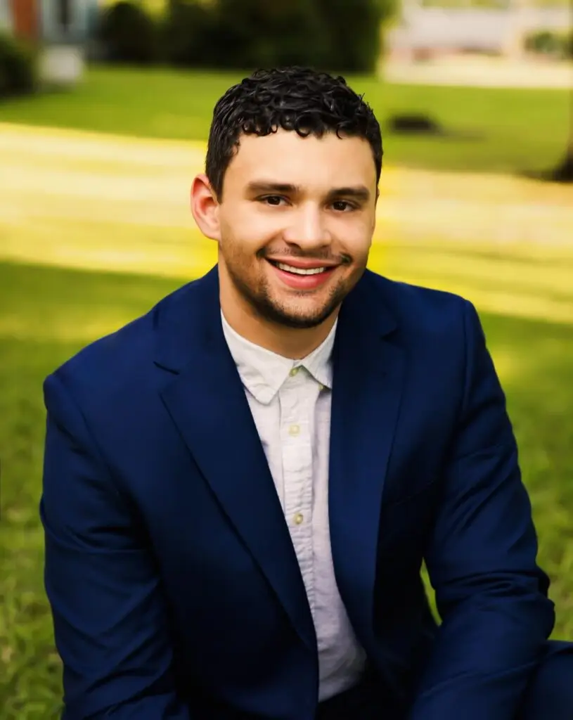 Tyler Vail Headshot, wearing a navy blue blazer and white shirt.